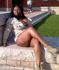 Chubby black chick spreading legs to show